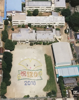写真：「祝120　2018」という校庭の人文字上空から撮影した様子